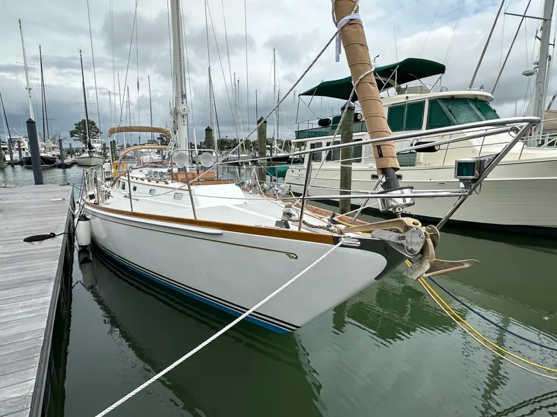 Slide: The Image of 1987 Hinckley Sou'wester 42 sailboat docked in a marina, overcast sky. - 17