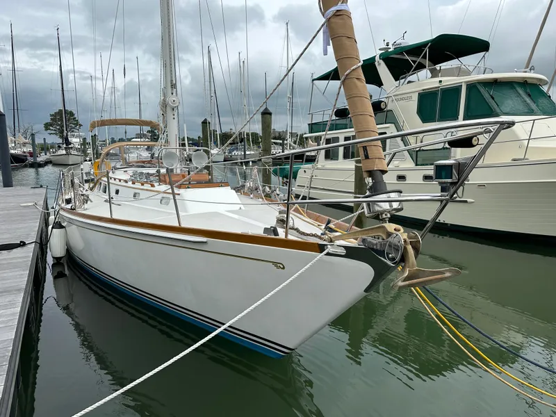 Slide: The Image of 1987 Hinckley Sou'wester 42 sailboat docked in a marina, overcast sky. - 18