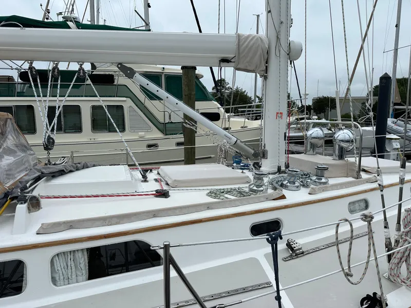 Slide: The Image of 1987 Hinckley Sou'wester 42 sailboat docked at marina, showcasing deck and rigging. - 21