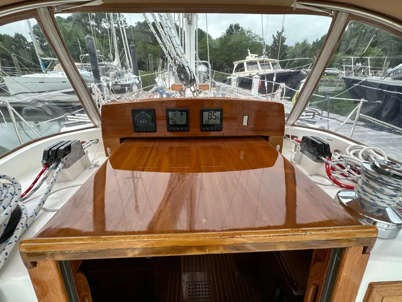 Slide: The Image of Hinckley Sou'wester 42 cockpit view, showcasing polished wood and navigation instruments, 1987 model. - 22
