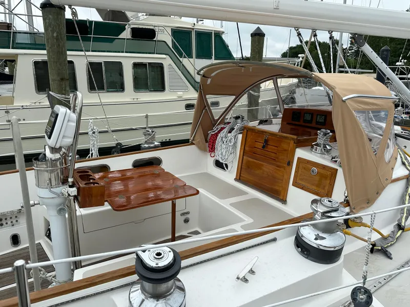 Slide: The Image of 1987 Hinckley Sou'wester 42 sailboat cockpit with wooden table and beige canopy. - 27