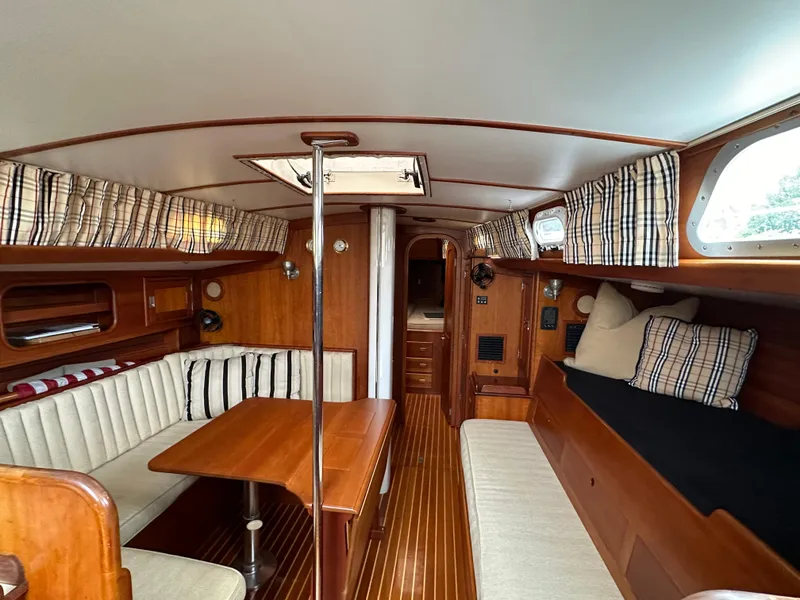 Slide: The Image of Interior of 1987 Hinckley Sou'wester 42 sailboat with wood finish and cozy seating area. - 3