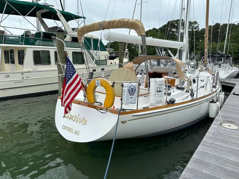 Slide: The Image of Hinckley Sou'wester 42 sailboat, 1987 model, docked with American flag, Oxford, MD. - 32