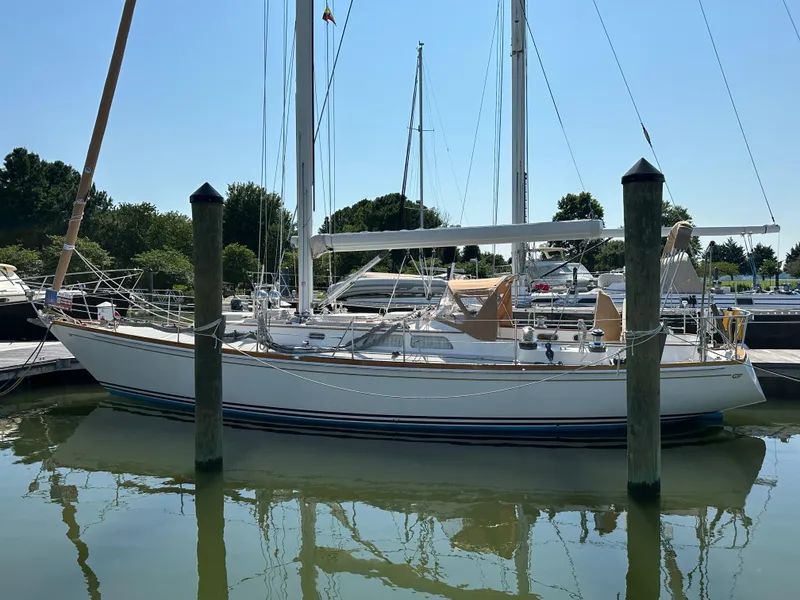 Slide: The Image of 1987 Hinckley Sou'wester 42 sailboat docked in a marina under clear skies. - 41
