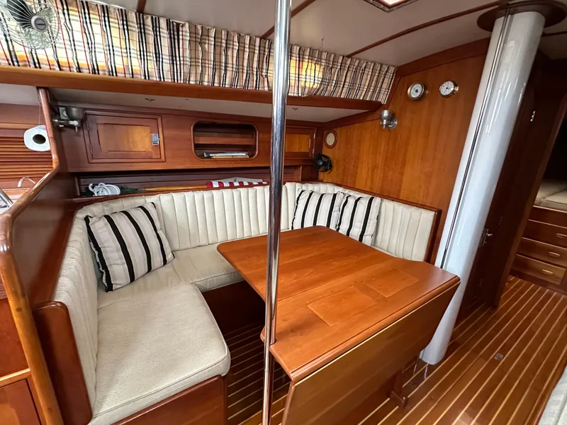 Slide: The Image of Interior of 1987 Hinckley Sou'wester 42 sailboat with wood finish and cozy seating area. - 6