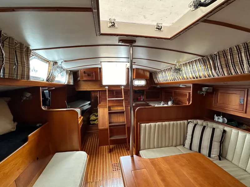 Slide: The Image of Interior of 1987 Hinckley Sou'wester 42 sailboat with wood finish and seating area. - 7
