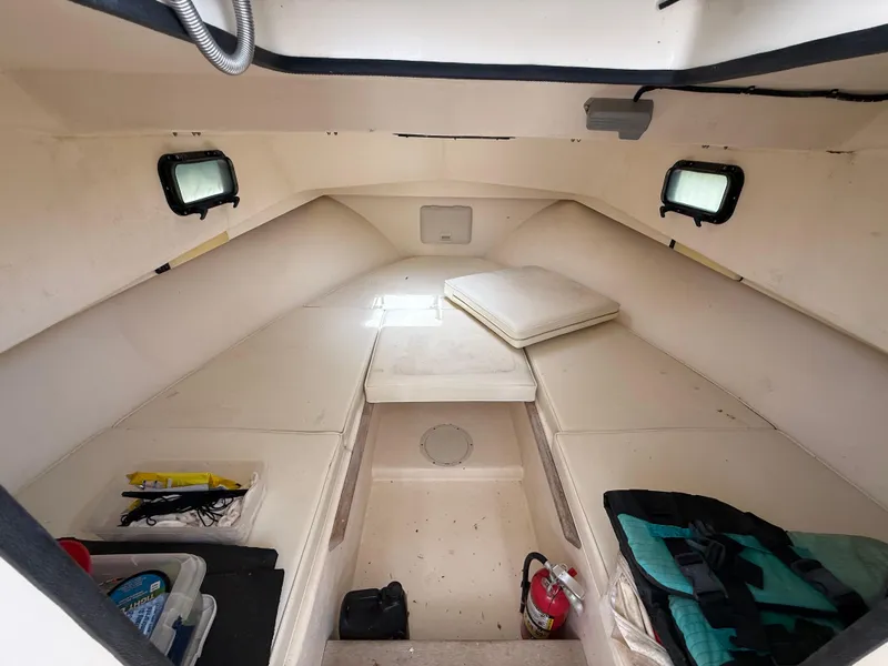 Slide: The Image of 2002 Parker 2510 Walkaround cabin interior with storage and seating. - 13
