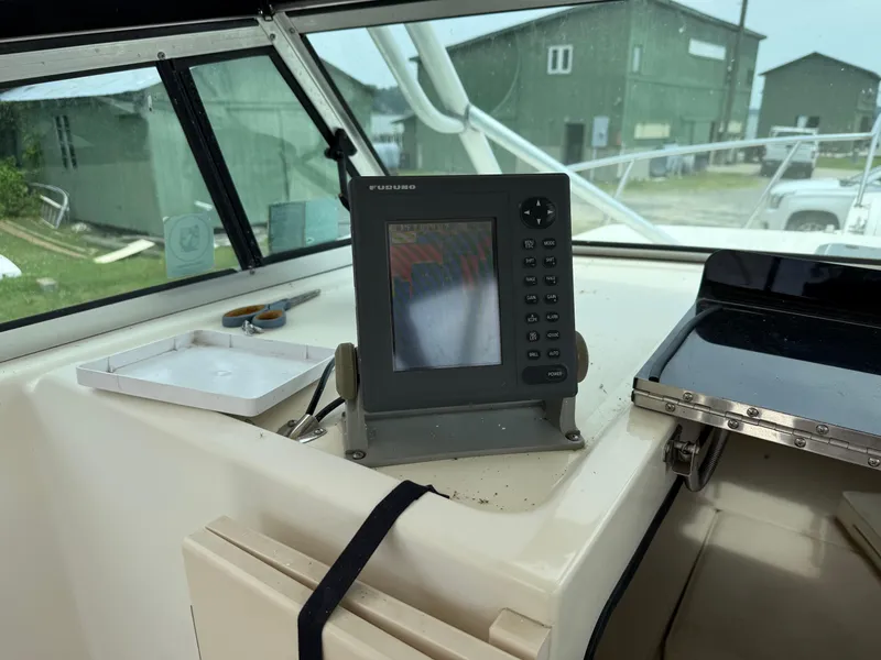 Slide: The Image of 2002 Parker 2510 Walkaround boat dashboard with navigation equipment. - 14