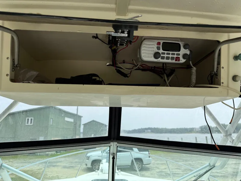 Slide: The Image of 2002 Parker 2510 Walkaround boat interior with open electronics compartment. - 16