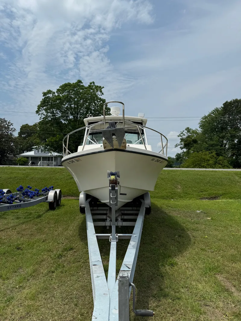 Slide: The Image of 2002 Parker 2510 Walkaround boat on trailer, parked on grassy area. - 17