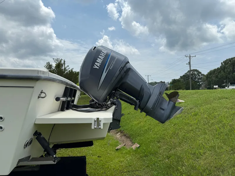Slide: The Image of 2002 Parker 2510 Walkaround boat with Yamaha outboard motor on grassy area. - 3