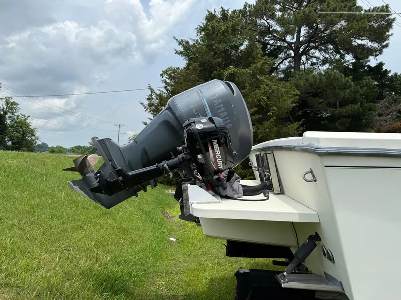 Slide: The Image of 2002 Parker 2510 Walkaround boat with Mercury outboard motor on grassy area. - 5