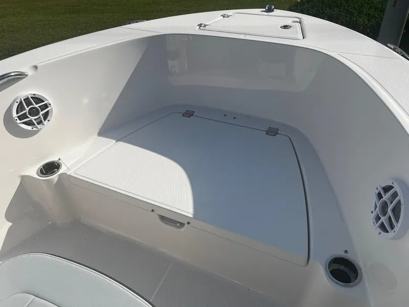Slide: The Image of 2025 Robalo R180 Center Console boat interior with seating and cup holders. - 10