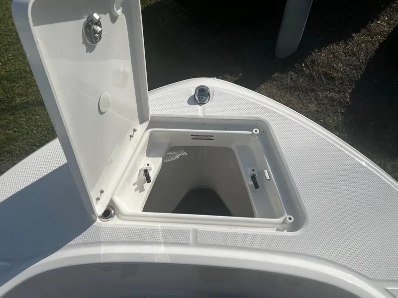 Slide: The Image of Open storage compartment on 2025 Robalo R180 Center Console boat. - 11