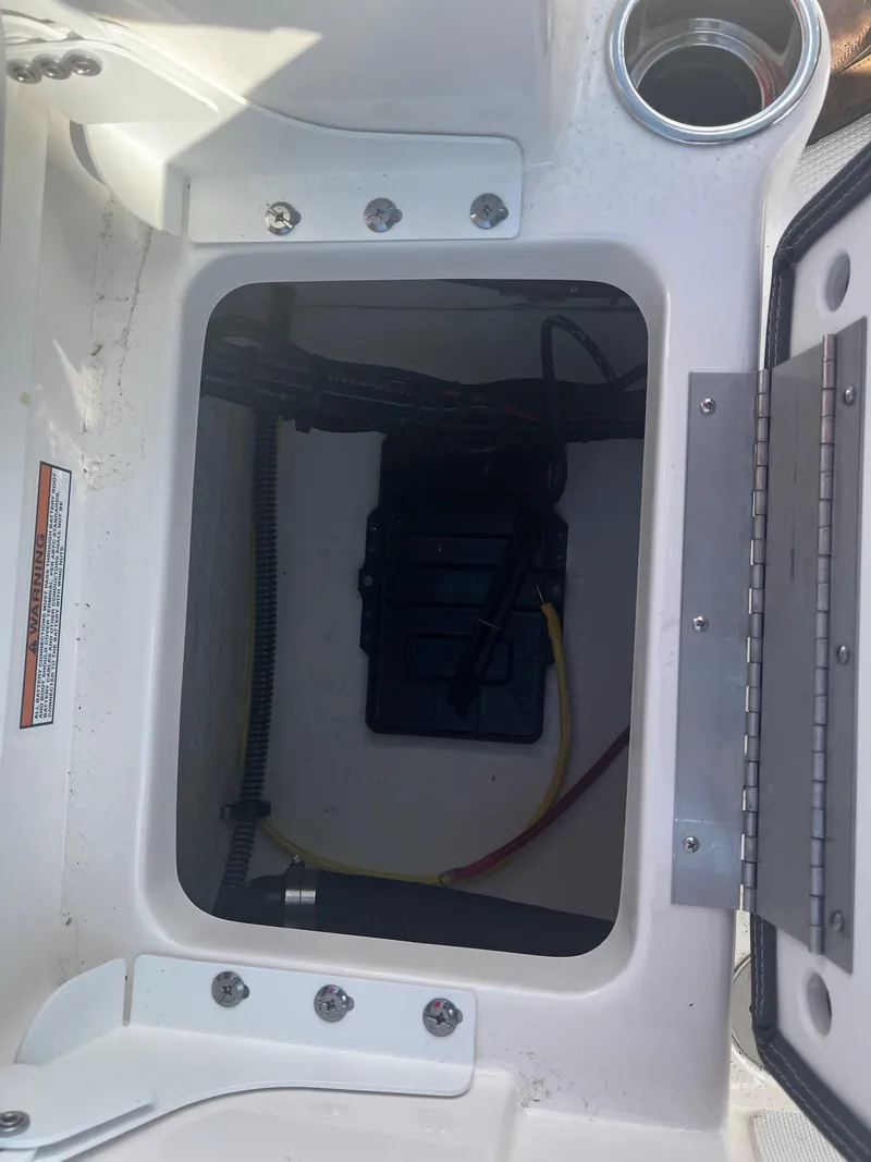 Slide: The Image of 2025 Robalo R180 Center Console storage compartment with wiring and battery box. - 14