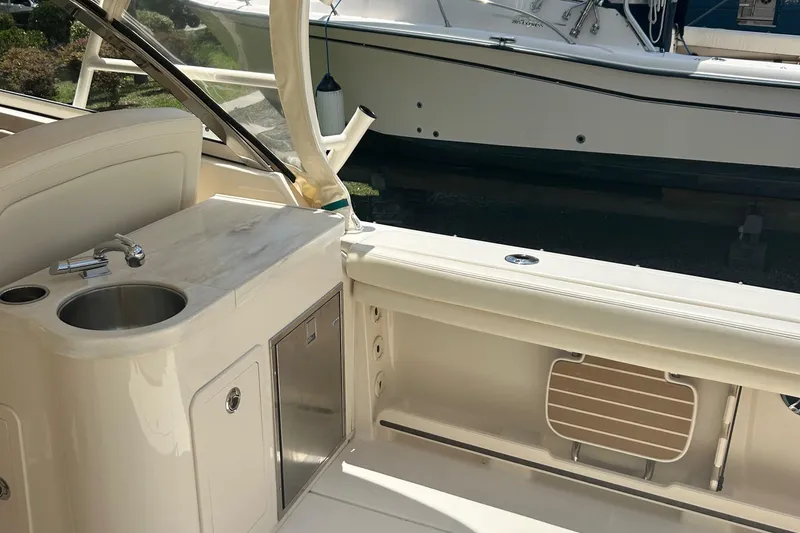Slide: The Image of 2020 Grady-White Freedom 307 boat interior with sink and storage area. - 26