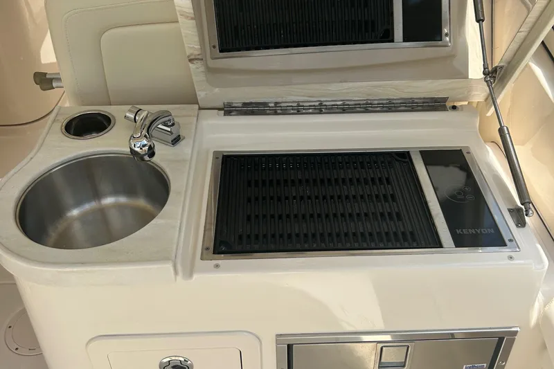 Slide: The Image of Outdoor kitchen on 2020 Grady-White Freedom 307 boat with sink and Kenyon grill. - 27