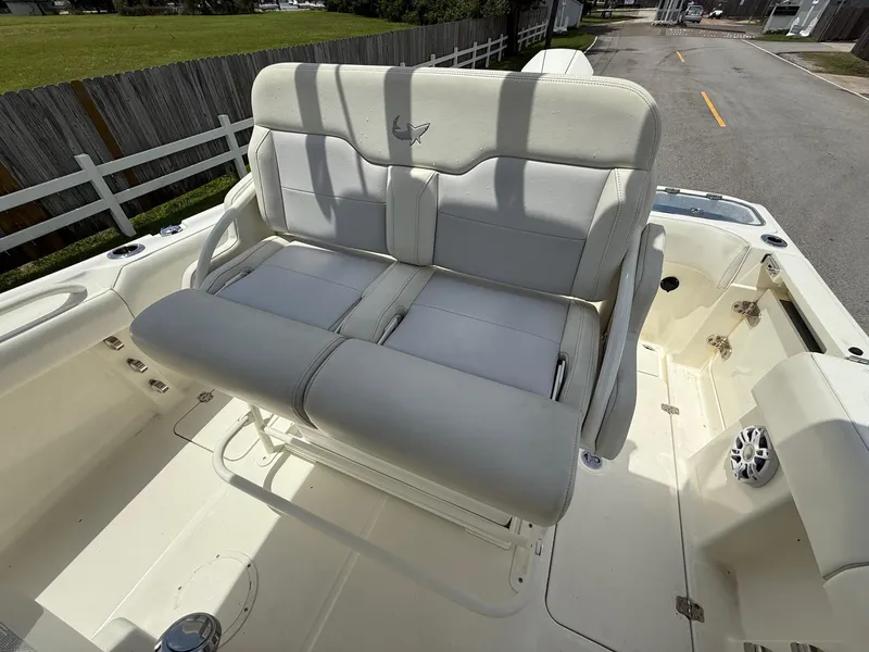 Slide: The Image of 2020 Mako 236 CC boat with dual cushioned seats and spacious deck. - 10