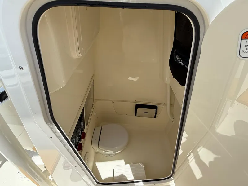 Slide: The Image of 2020 Mako 236 CC boat interior with compact marine toilet. - 16