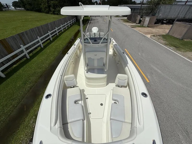 Slide: The Image of 2020 Mako 236 CC boat with spacious seating and sleek design on a road. - 17