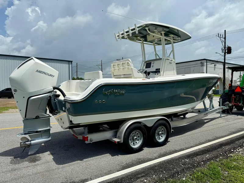 Slide: The Image of 2020 Mako 236 CC boat on trailer with Mercury outboard engine, parked on roadside. - 4