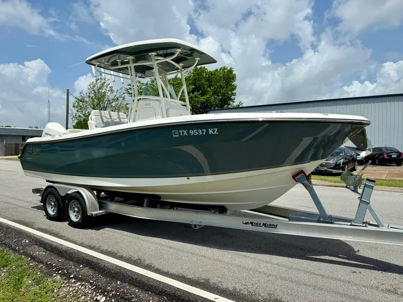 Slide: The Image of 2020 Mako 236 CC boat on trailer, parked outdoors under a cloudy sky. - 5