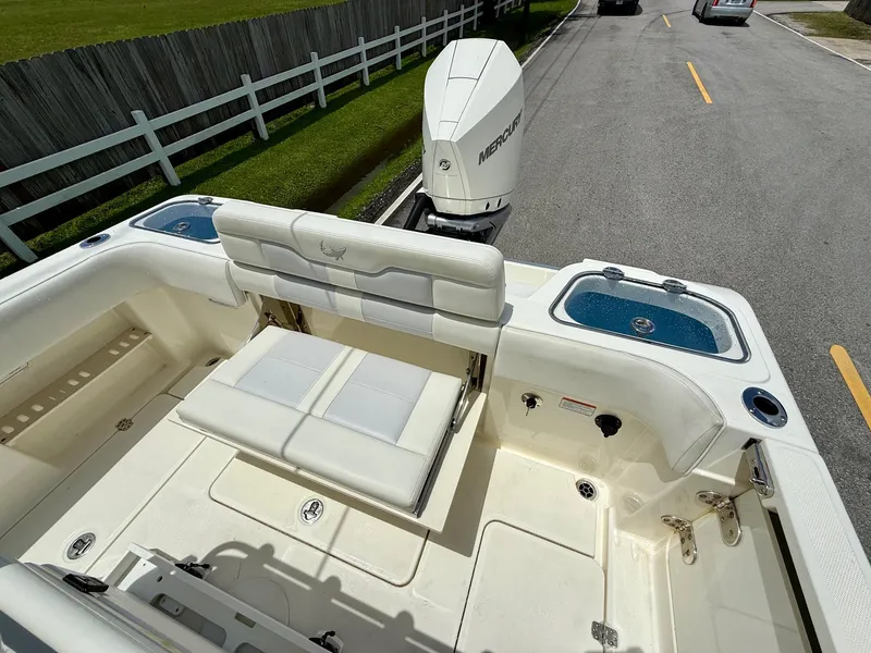 Slide: The Image of 2020 Mako 236 CC boat with Mercury engine, featuring seating and storage compartments. - 7