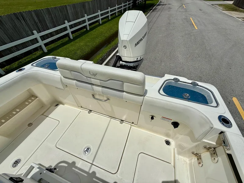 Slide: The Image of 2020 Mako 236 CC boat deck with Mercury outboard motor on a road. - 8