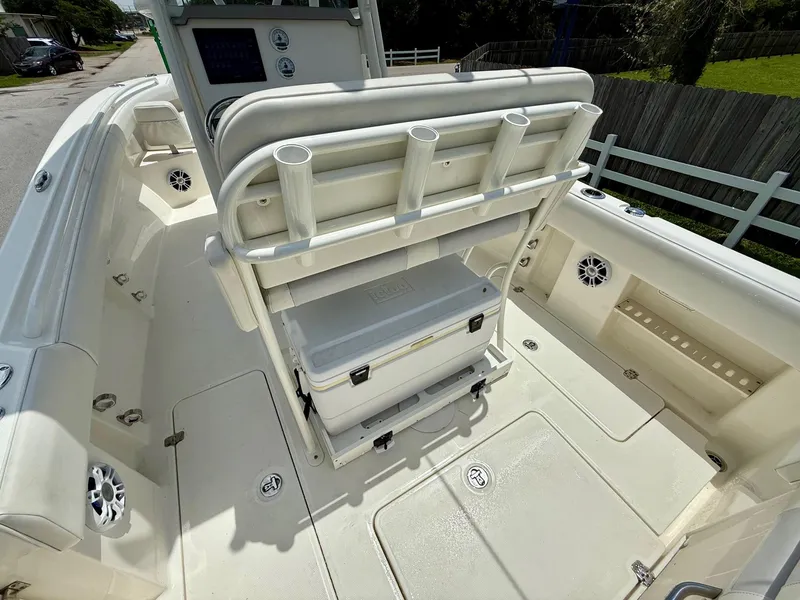 Slide: The Image of 2020 Mako 236 CC boat interior with rod holders and storage compartments. - 9