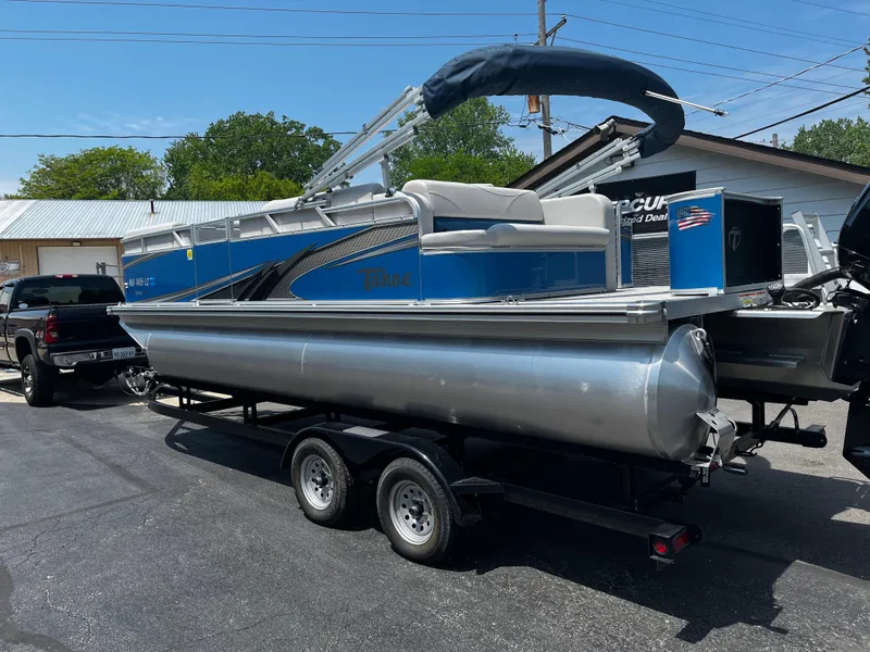 Slide: The Image of 2022 Tahoe 182 S pontoon boat on trailer, parked outdoors. - 14