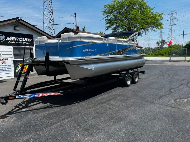 Slide: The Image of 2022 Tahoe 182 S pontoon boat on trailer at dealership, sunny day. - 16