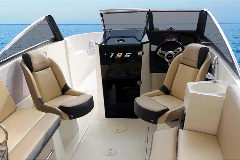 Slide: The Image of 2025 Ventura V195 Crossover boat interior with beige seating and steering console. - 5