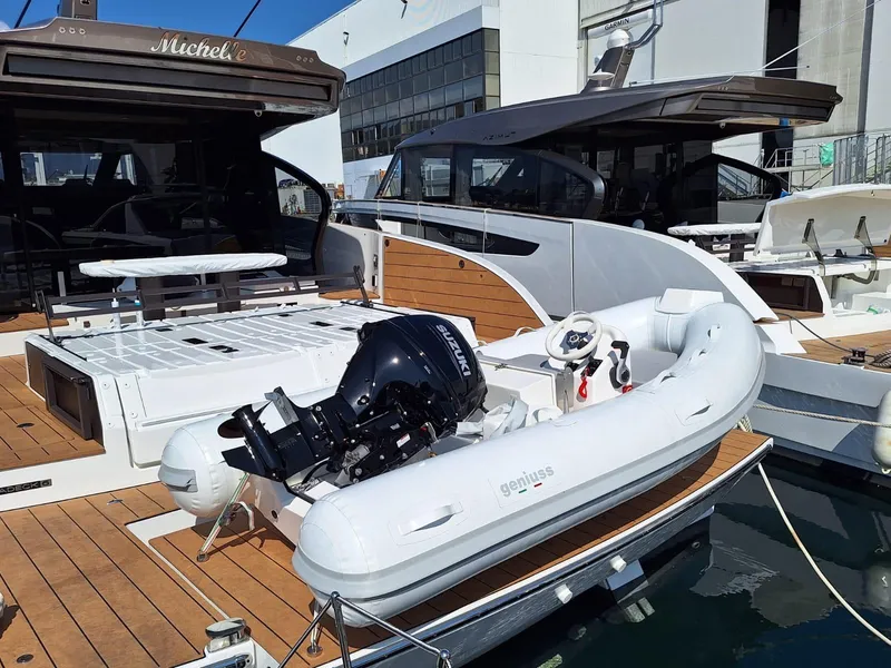 Slide: The Image of 2025 Geniuss 330 Cruiser docked with inflatable boat and outboard motor. - 10