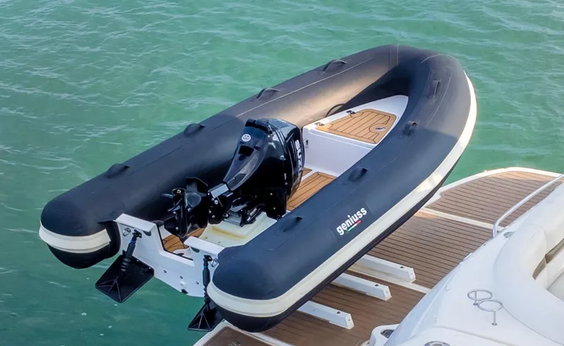 Slide: The Image of 2025 Geniuss 330 Cruiser inflatable boat on water, featuring sleek design and powerful motor. - 17