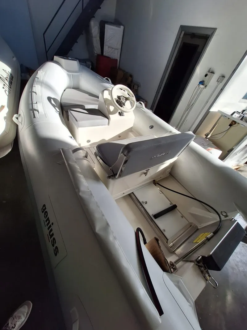 Slide: The Image of 2025 Geniuss 330 Cruiser inflatable boat in a garage setting. - 19