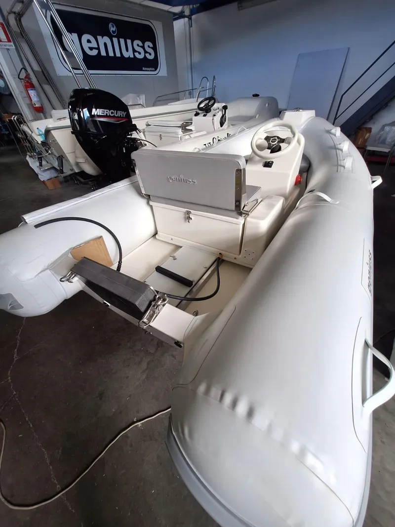 Slide: The Image of 2025 Geniuss 330 Cruiser inflatable boat with Mercury engine in a showroom. - 23