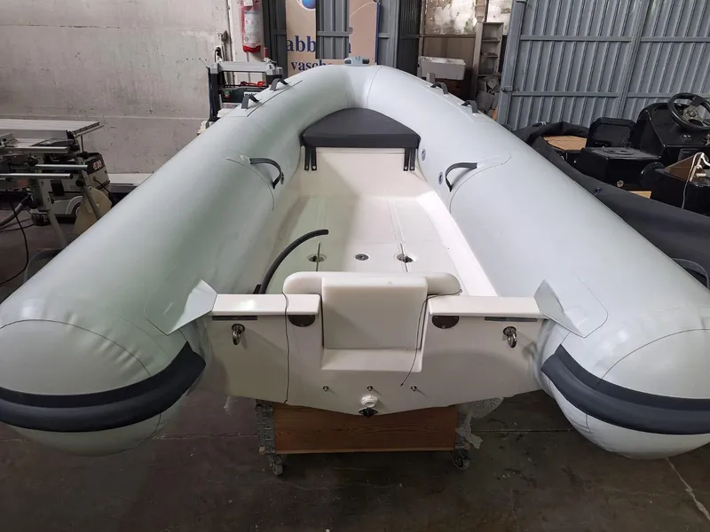 Slide: The Image of 2025 Geniuss 330 Cruiser inflatable boat in a workshop setting. - 26