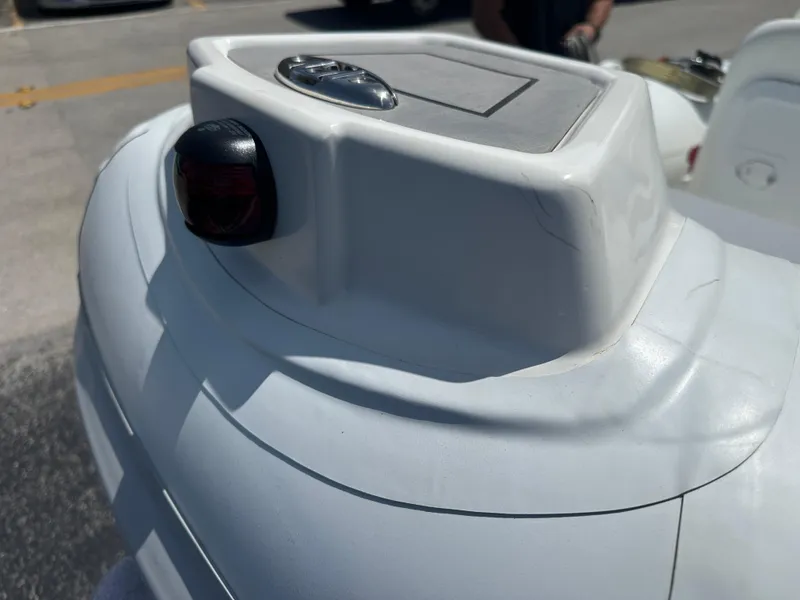 Slide: The Image of Close-up of a 2025 Geniuss 330 Cruiser boat detail, featuring sleek white design. - 5