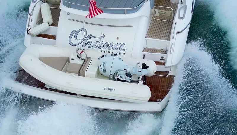 Slide: The Image of Aerial view of 2025 Geniuss 330 Cruiser yacht with American flag and tender boat. - 7