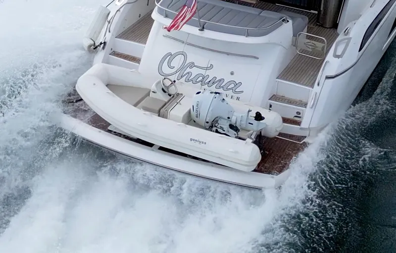 Slide: The Image of Sleek 2025 Geniuss 330 Cruiser yacht with American flag, navigating through waves. - 9