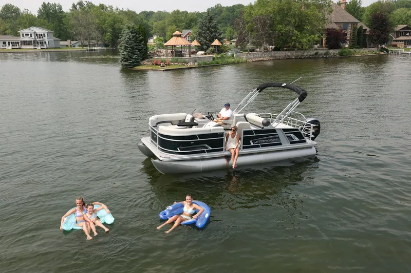 Slide: The Image of Starcraft EX 20 pontoon boat on a serene lake, 2026 model. - 3