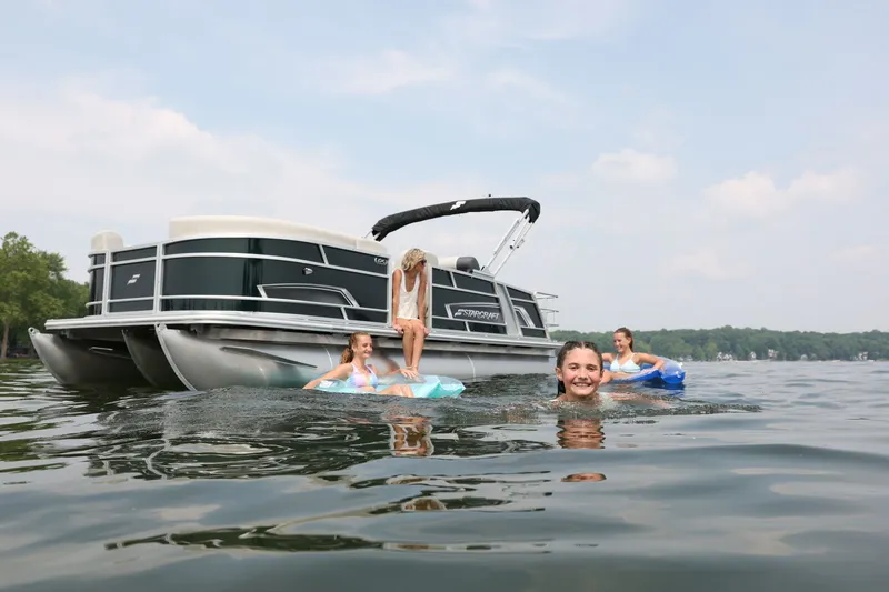 Slide: The Image of Starcraft EX 20 pontoon boat 2026 with people swimming nearby. - 4