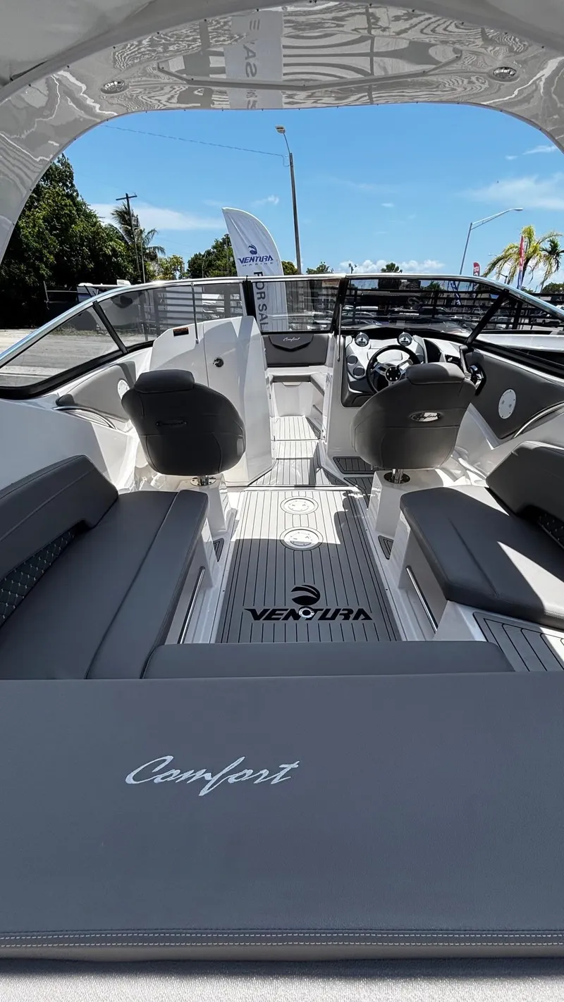 Slide: The Image of 2025 Ventura V250 Comfort boat interior with sleek seating and modern dashboard design. - 5