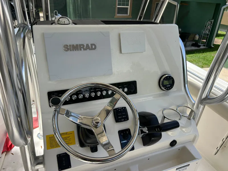 Slide: The Image of 2023 Key West 239 FS boat console with Simrad navigation system and steering wheel. - 10