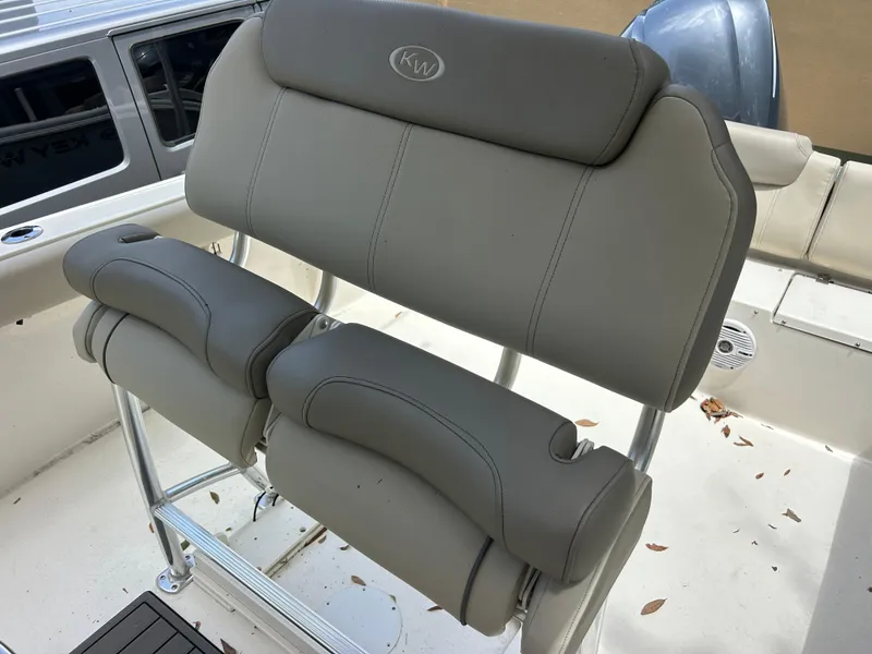 Slide: The Image of 2023 Key West 239 FS boat seating with gray upholstery and metal frame. - 11