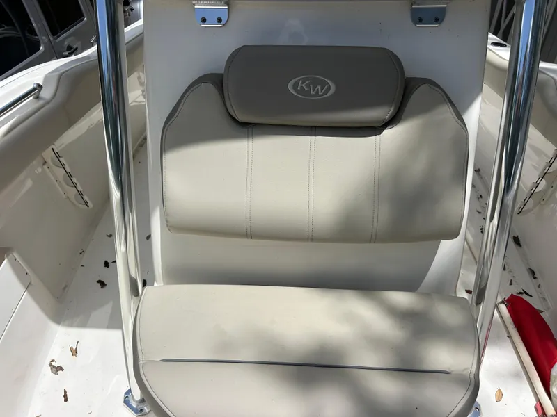 Slide: The Image of 2023 Key West 239 FS boat seat with beige upholstery and KW logo. - 12