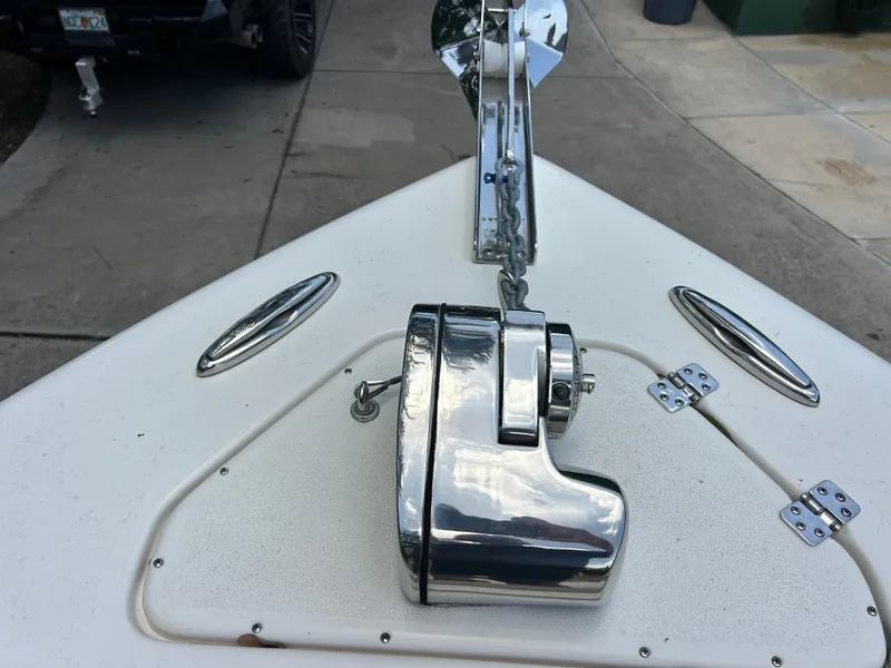 Slide: The Image of 2023 Key West 239 FS boat anchor system on deck, featuring polished metal components. - 14