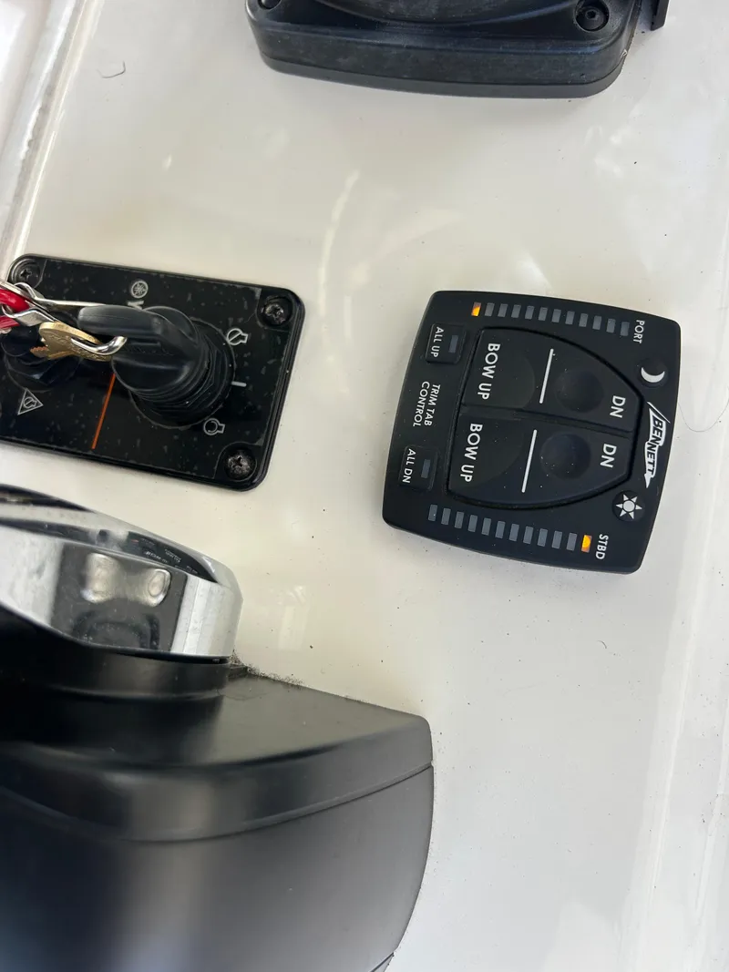 Slide: The Image of Control panel of a 2023 Key West 239 FS boat with switches and buttons. - 17