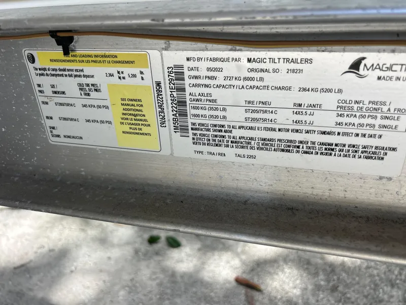 Slide: The Image of Label on Magic Tilt trailer showing specifications and safety information. - 21