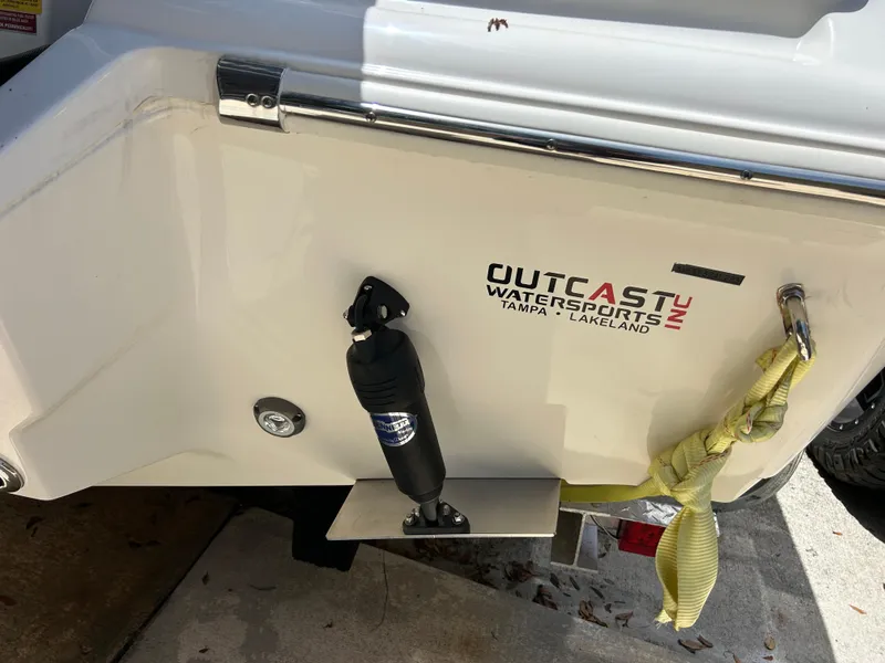 Slide: The Image of 2023 Key West 239 FS boat stern with Outcast Watersports logo and yellow strap. - 6